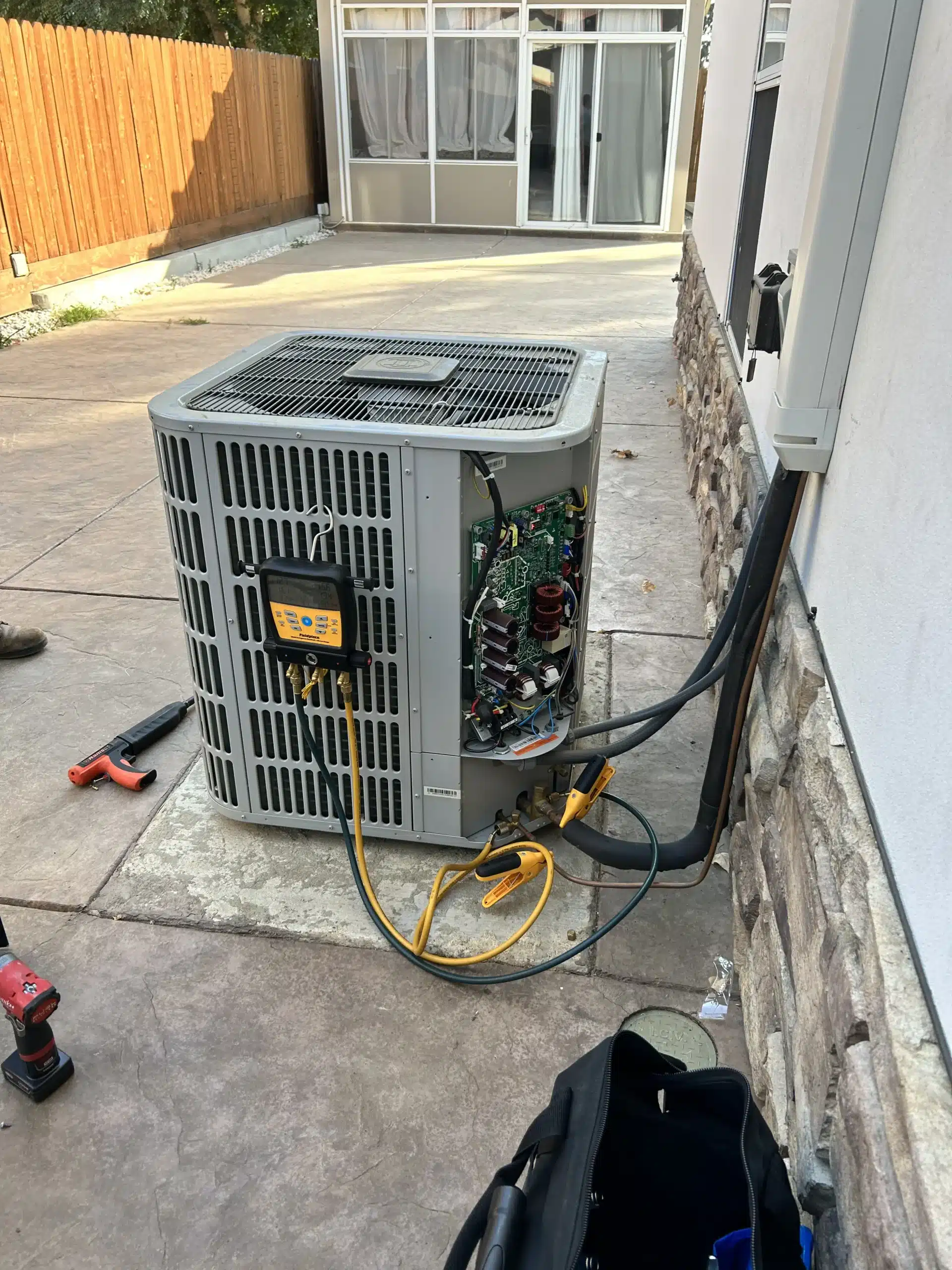 Central Elite technician installing an air conditioning system in a Fresno CA home