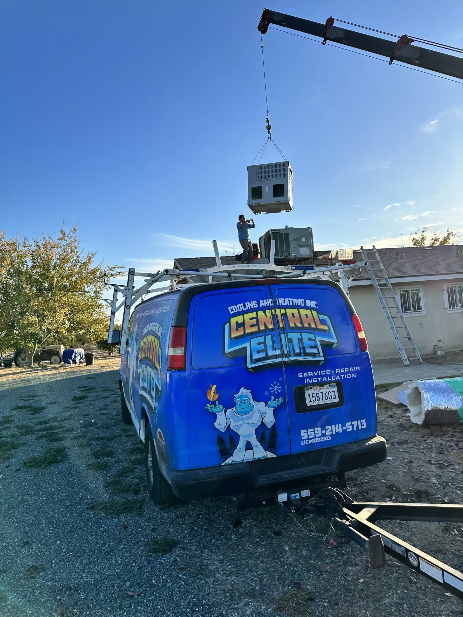 Central Elite HVAC technician diagnosing and repairing a residential air conditioner in Fresno CA