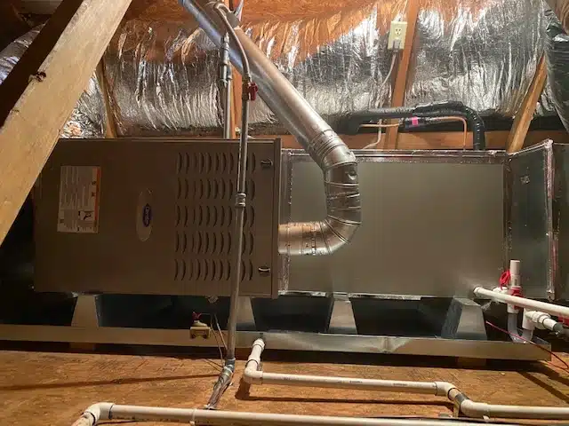 A central furnace and air handler with new ductwork installed in a Fresno attic